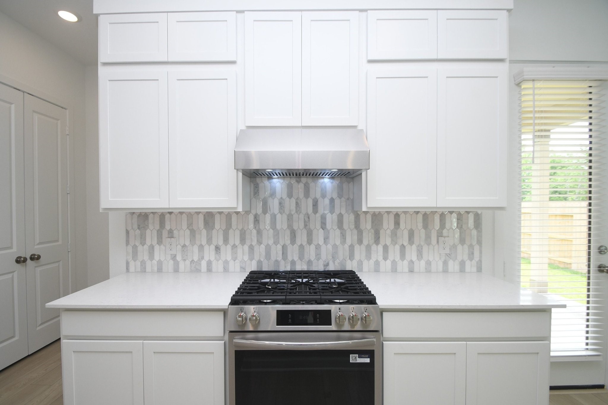 4227 Eagle Pass Drive Rosenberg, TX 77469 - Photo 5 of 28 Beautiful backslash and modern vent hood. Notice the microwave is located away from the vent hood.