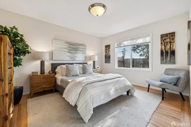 a bedroom with a bed and a large window