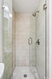 a bedroom with a bed and painting on the wall