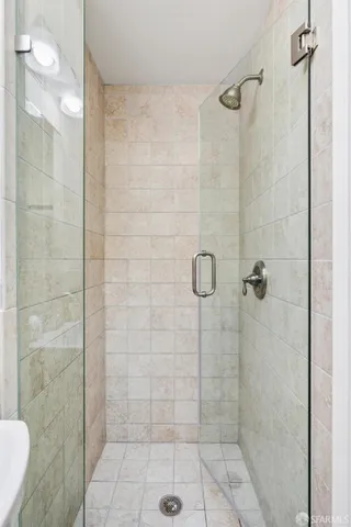 a bedroom with a bed and painting on the wall