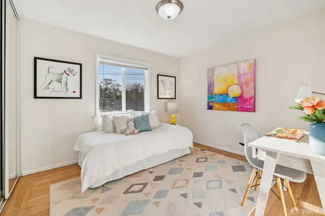 a bedroom with a bed and a table in it