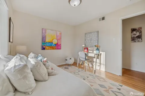 a bedroom with a bed and a potted plant