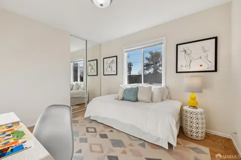 a view of a livingroom with chairs and a stove