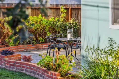 a dining room with furniture and garden view