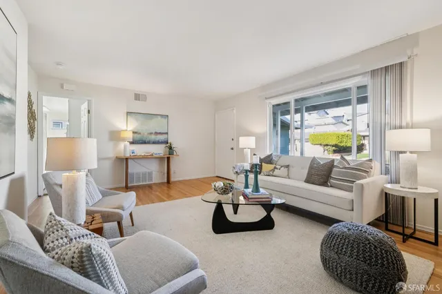 a kitchen with white cabinets and sink