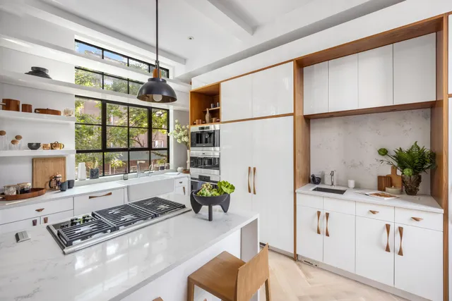 a kitchen with a sink stove and cabinets
