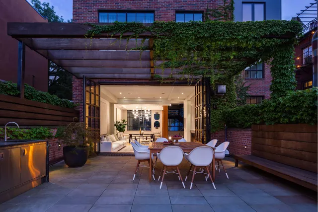 a view of a patio with table and chairs and potted plants