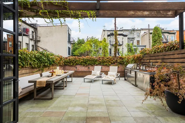 a view of a dining room with furniture and a potted plant