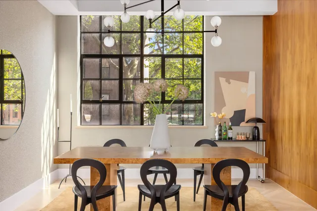 a living room with furniture large window and fireplace