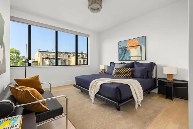 a living room with furniture and a floor to ceiling window