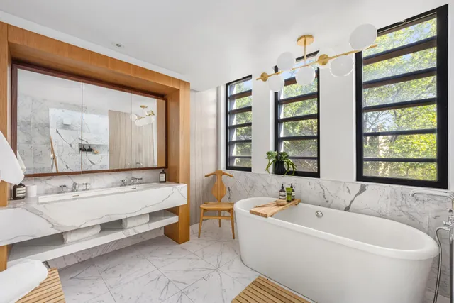 a spacious bedroom with a bed and glass window