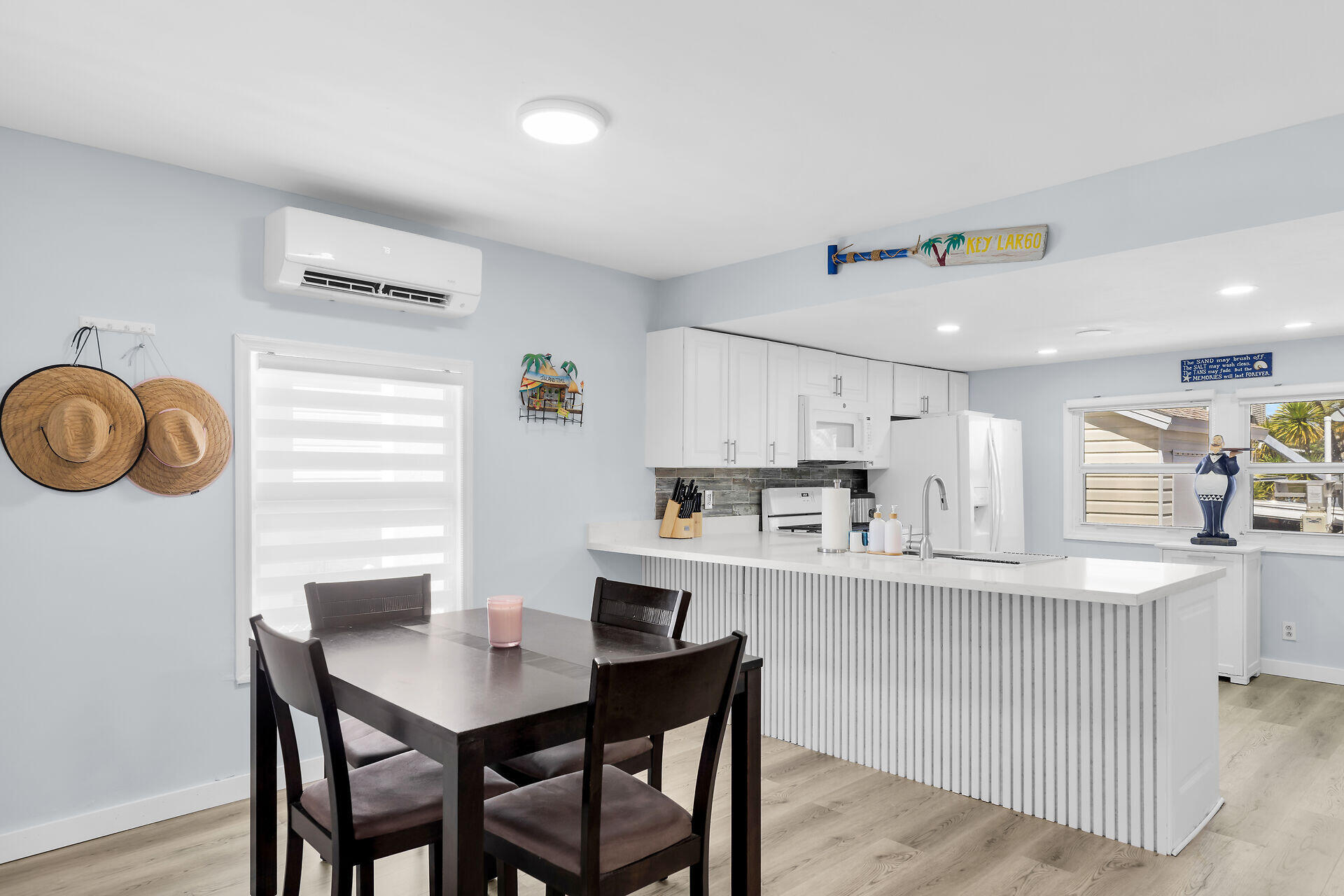 209 Buttonwood Avenue Key Largo, FL 33037 - Photo 14 of 46 a kitchen with kitchen island white cabinets and refrigerator