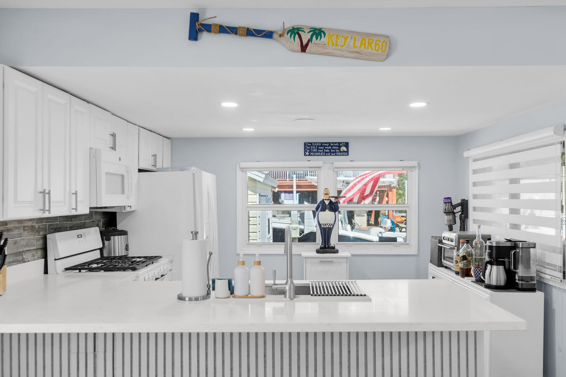 209 Buttonwood Avenue Key Largo, FL 33037 - Photo 17 of 46 a kitchen with stainless steel appliances granite countertop a sink and cabinets