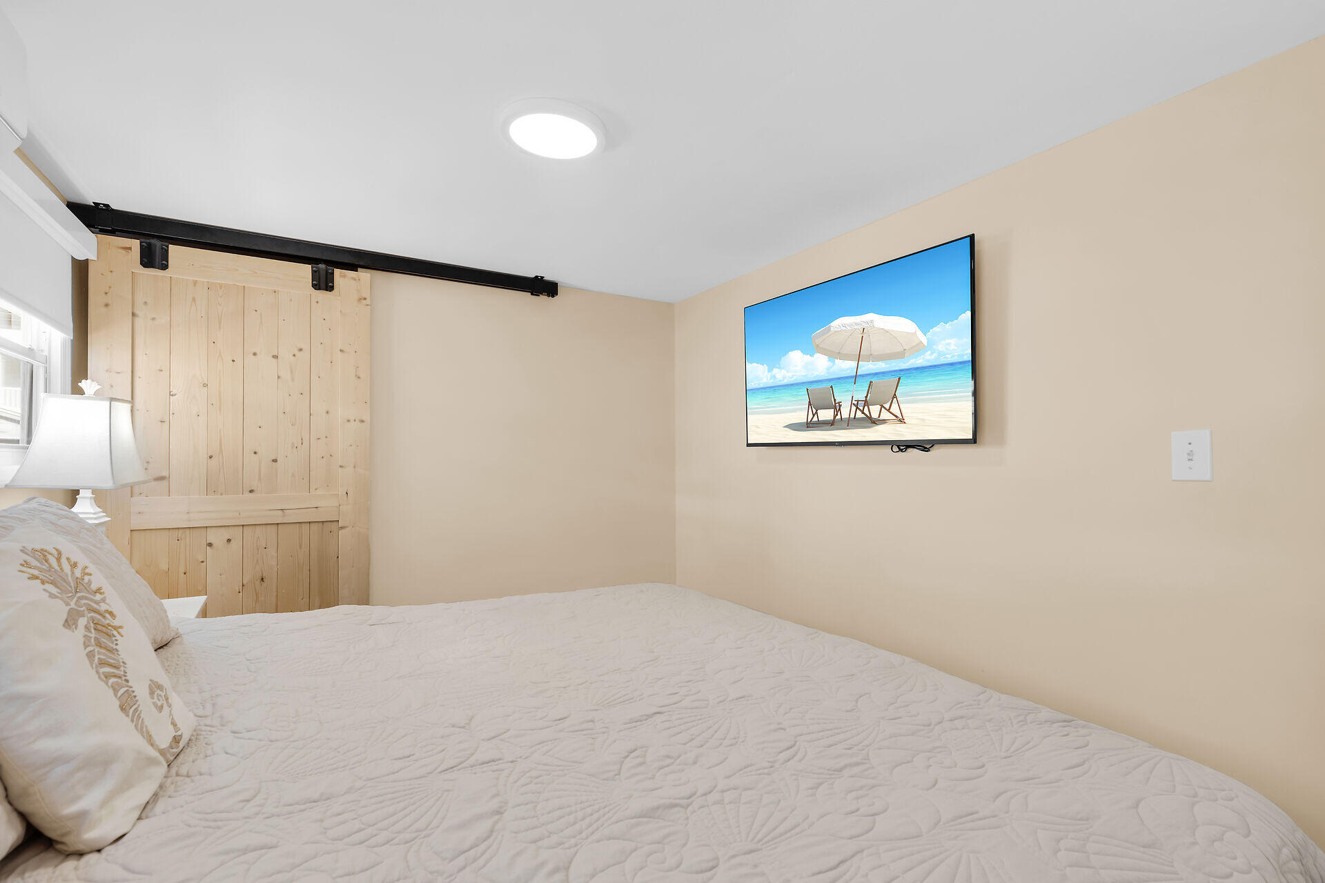 209 Buttonwood Avenue Key Largo, FL 33037 - Photo 23 of 46 a bedroom with a large bed and a painting on the wall