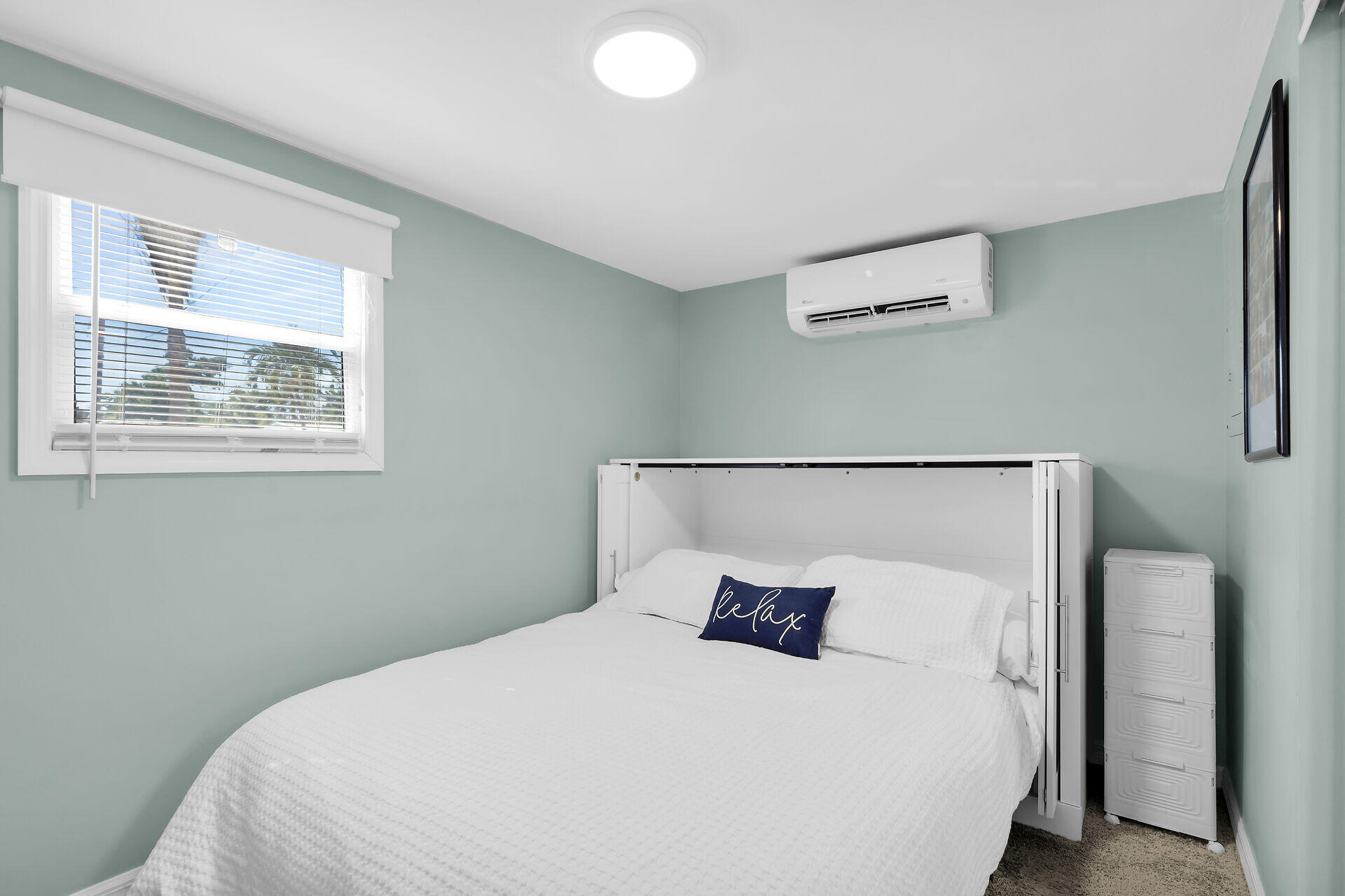 209 Buttonwood Avenue Key Largo, FL 33037 - Photo 27 of 46 a large bed sitting in a bedroom next to a window