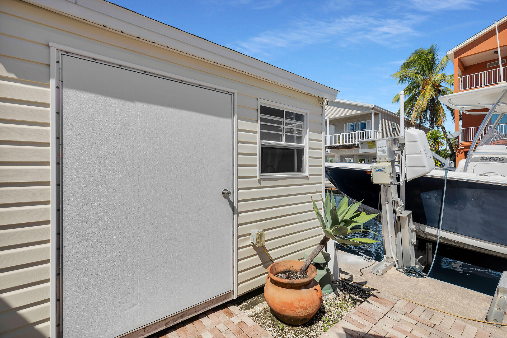 209 Buttonwood Avenue Key Largo, FL 33037 - Photo 32 of 46 a view of a patio with table and chairs and potted plants