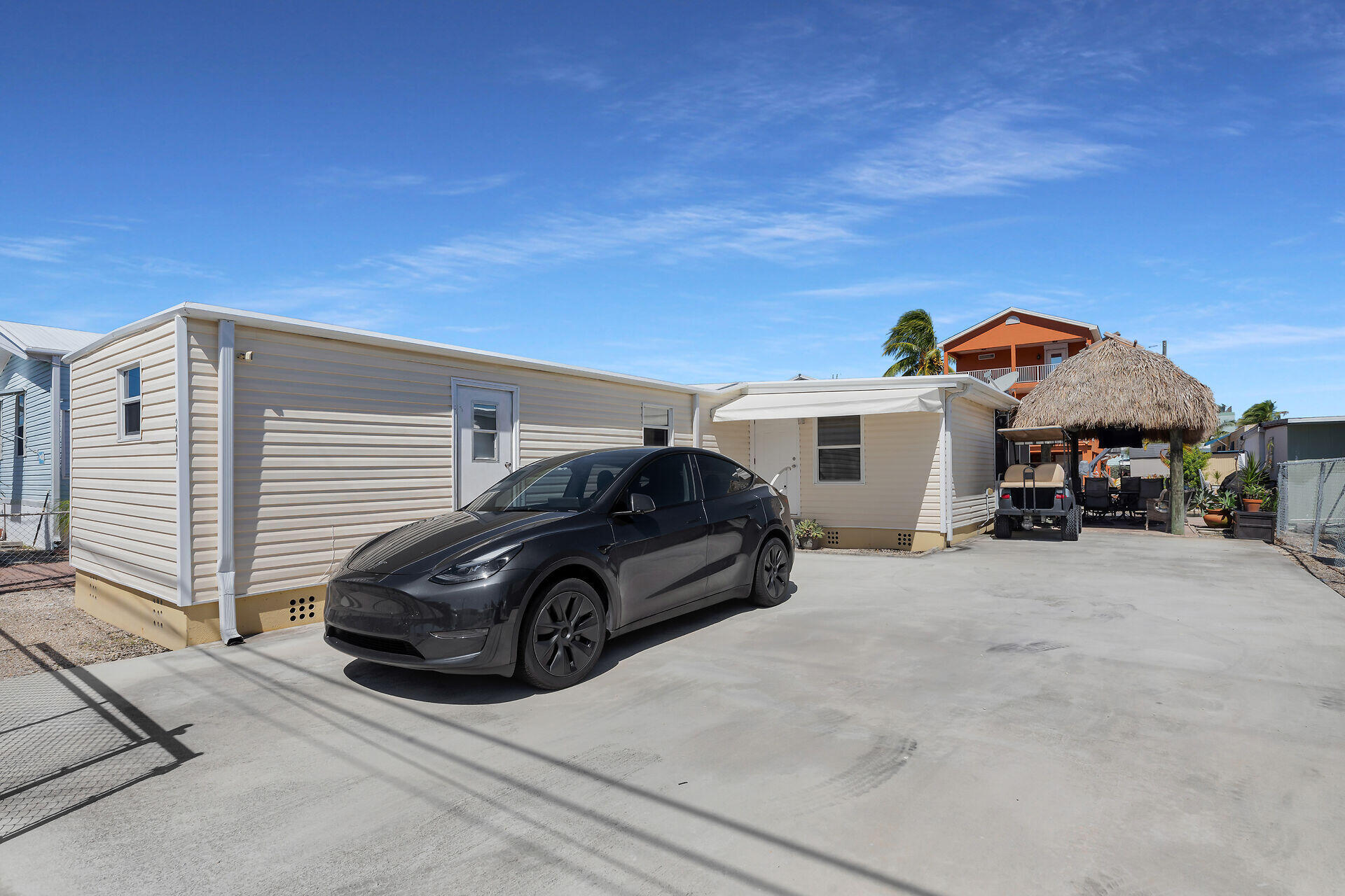209 Buttonwood Avenue Key Largo, FL 33037 - Photo 34 of 46 a car parked in front of a house