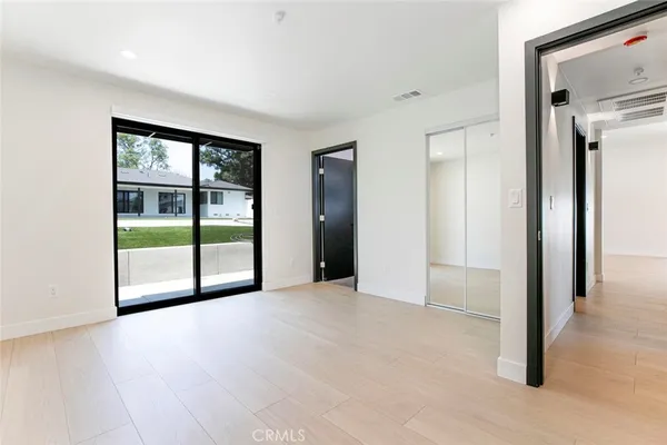 a view of an empty room with glass door