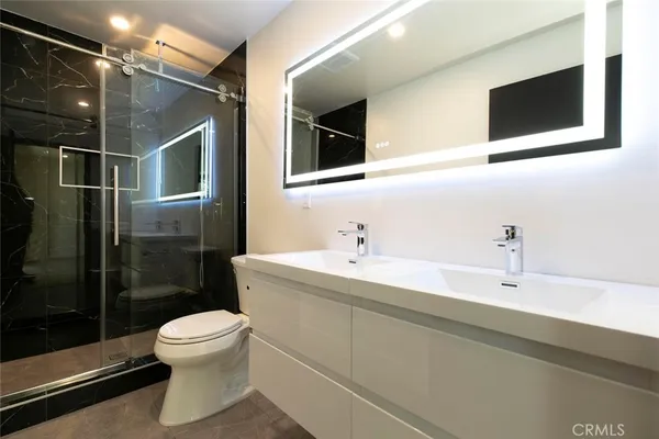 a bathroom with a toilet sink and shower