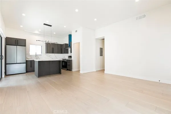 a view of a kitchen with a sink and a refrigerator