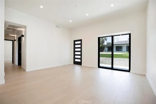 an empty room with windows and closet