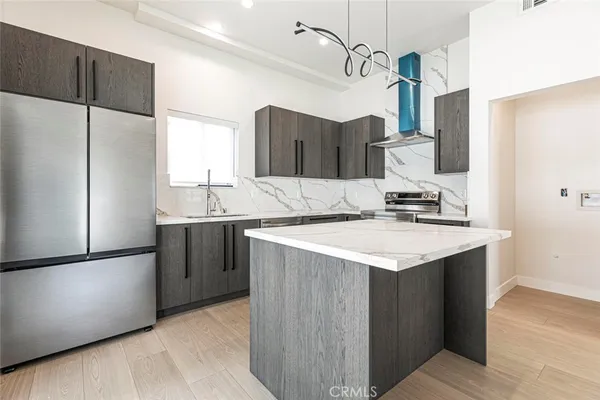a kitchen with a sink a refrigerator and a stove