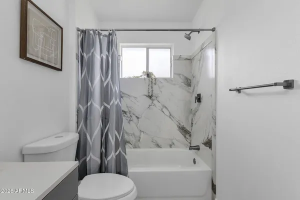 a bathroom with a toilet and a bathtub