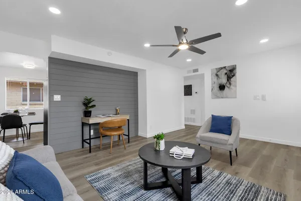 a living room with furniture and a wooden floor