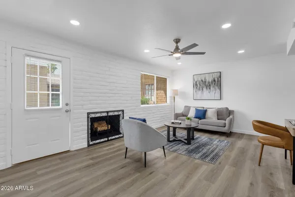 a living room with furniture and a fireplace