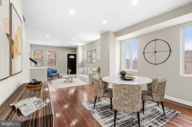 a living room with furniture a mirror and a table