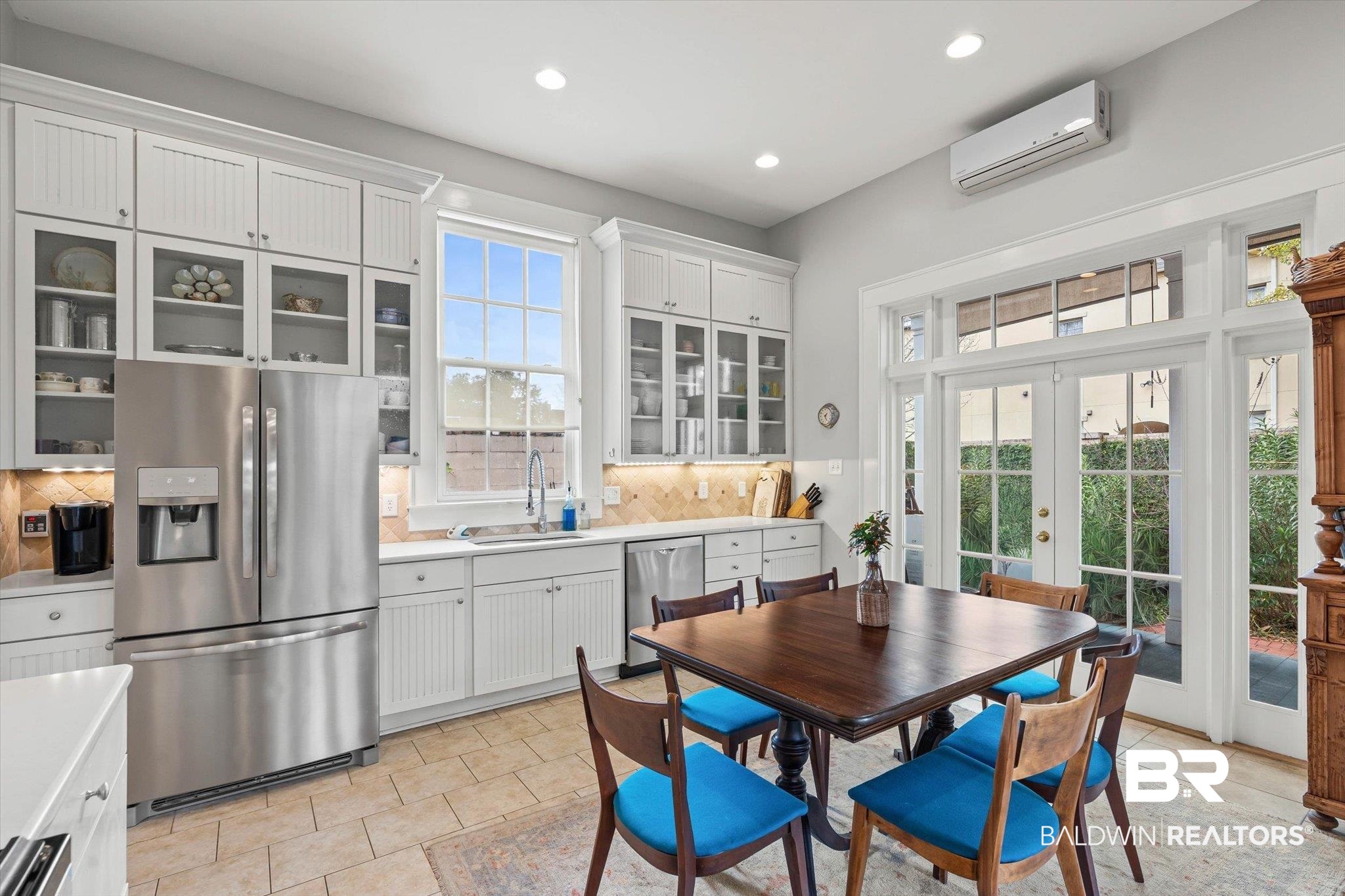 259 North Jackson Street Mobile, AL 36603 - Photo 13 of 42 Kitchen with glass insert cabinets, appliances with stainless steel finishes, french doors, backsplash, and white cabinetry