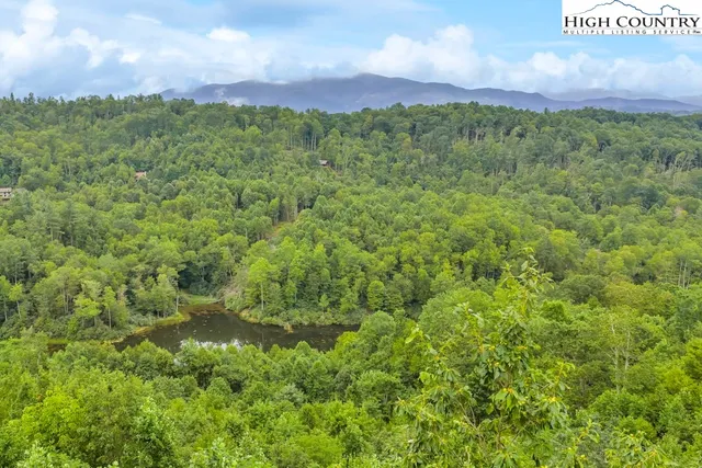 a view of a lush green hillside and a building