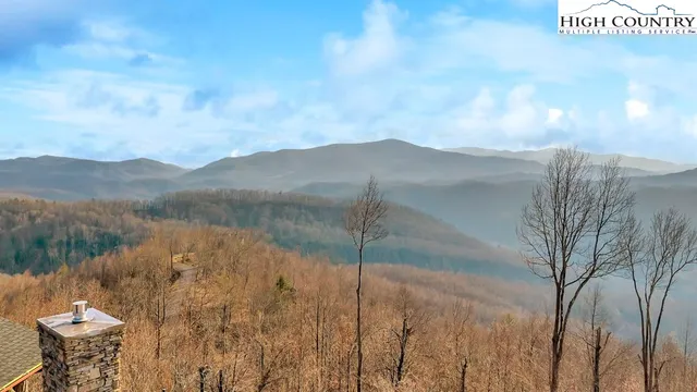 a view of a dry yard with mountains in the background