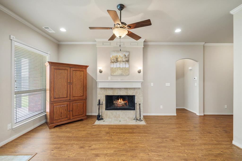 1852 Meadowview Canton, TX 75103 - Photo 6 of 28 a view of a livingroom with a fireplace a ceiling fan and window