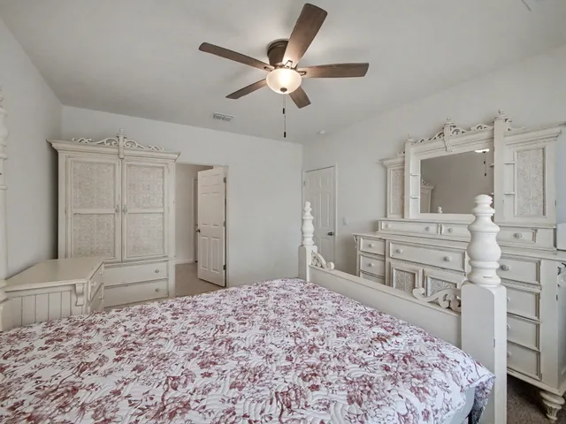 a bedroom with a bed and a dresser