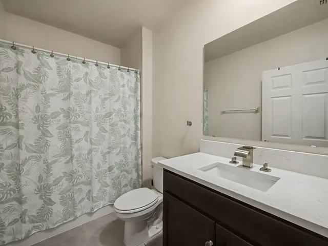 a bathroom with a sink a toilet and a mirror