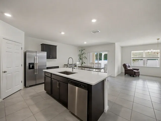 a kitchen with refrigerator and furniture