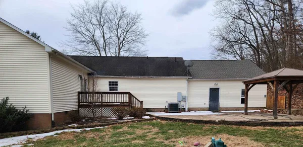 a backyard of house with large trees and pool
