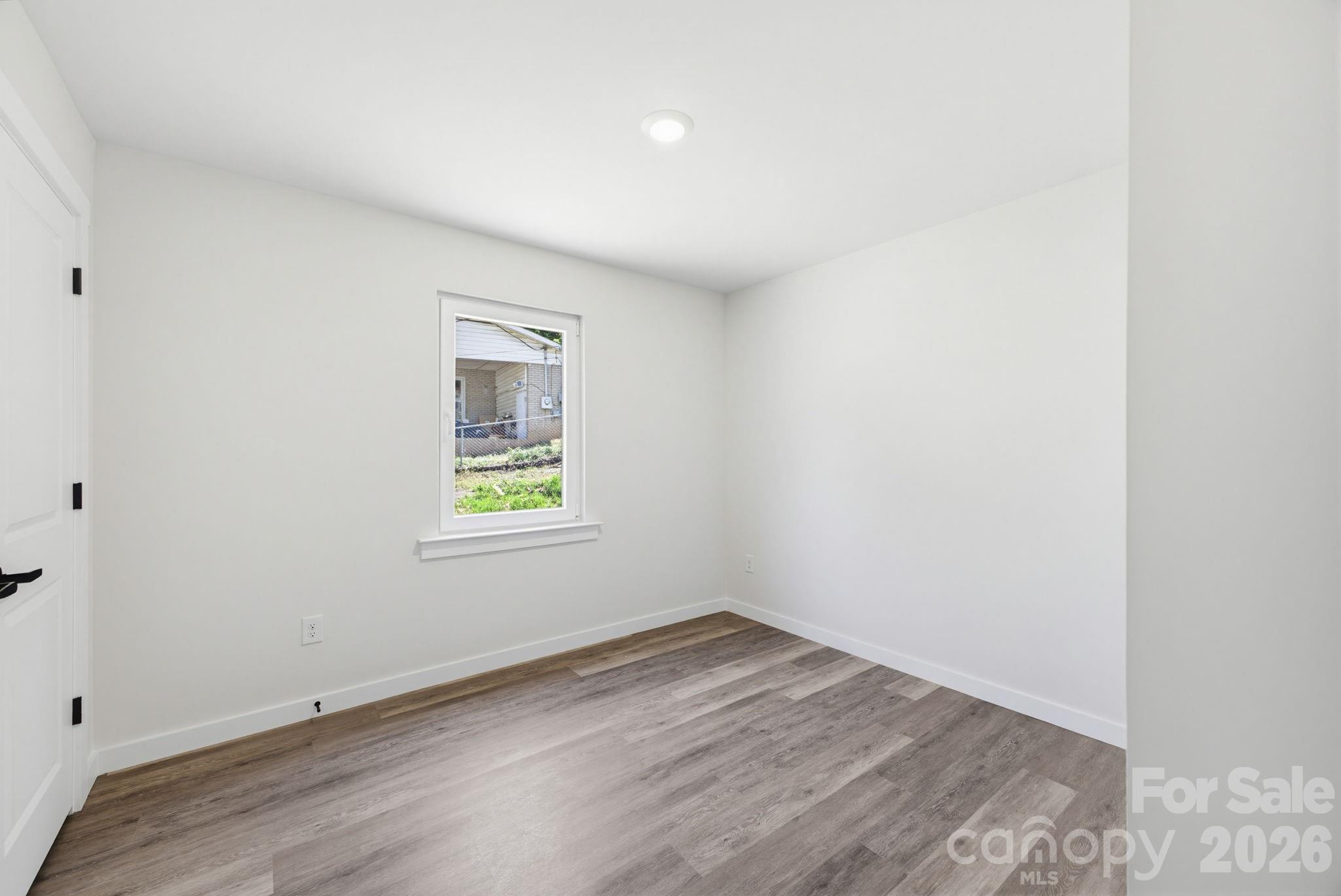 701 2nd St Place Southwest Conover, NC 28613 - Photo 15 of 16 an empty room with wooden floor and windows