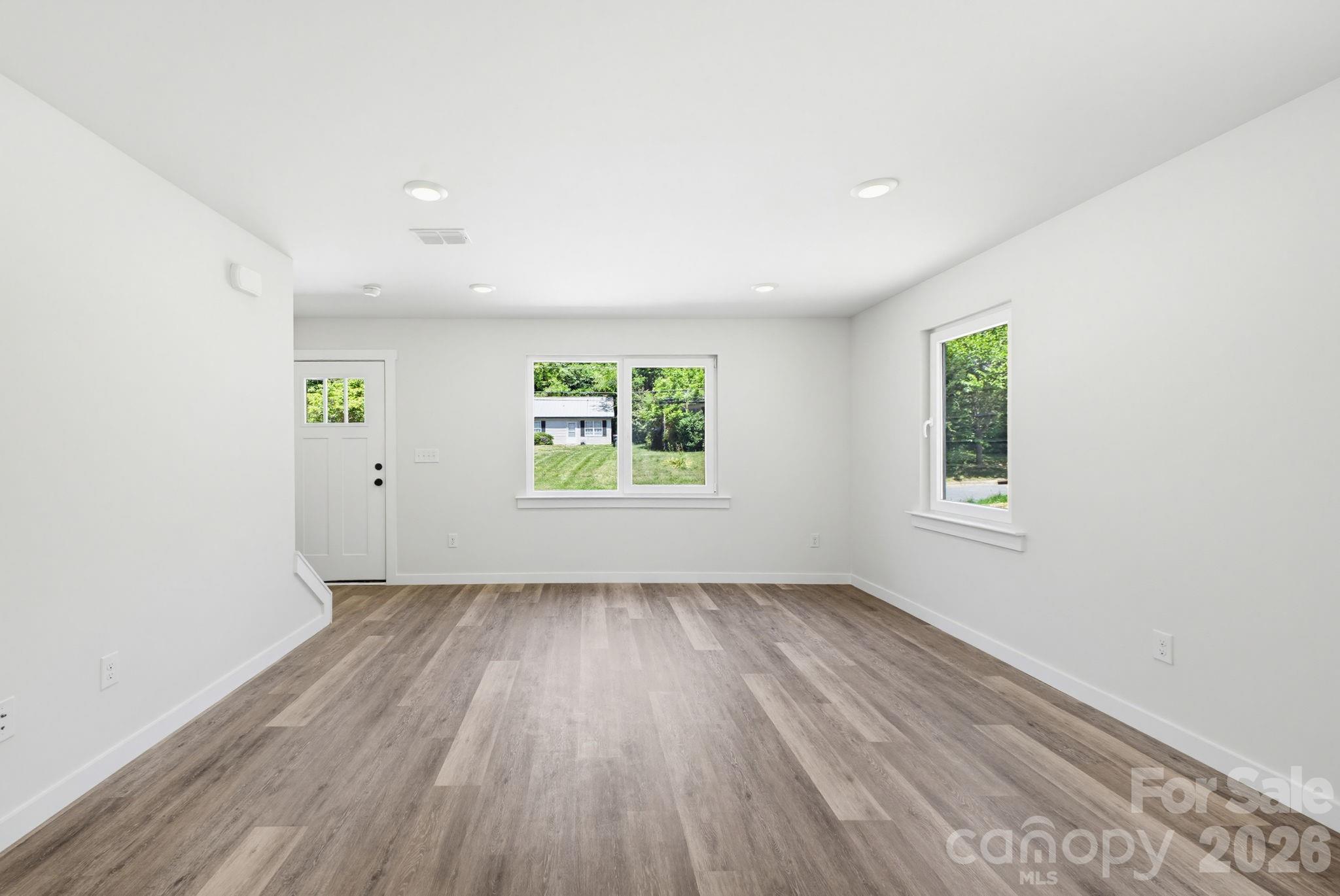 701 2nd St Place Southwest Conover, NC 28613 - Photo 5 of 16 an empty room with wooden floor and windows