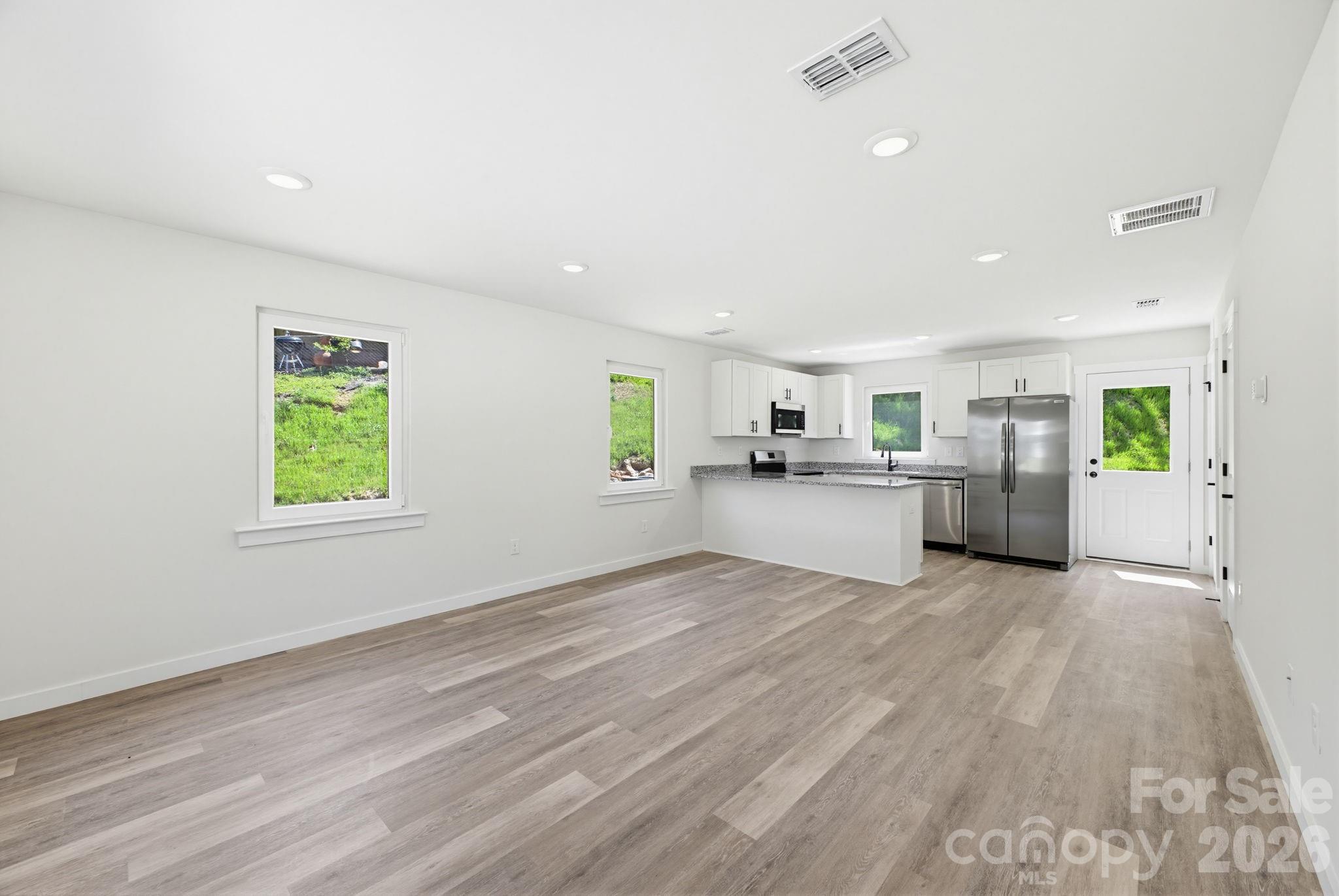 701 2nd St Place Southwest Conover, NC 28613 - Photo 7 of 16 a view of a big room with wooden floor and windows