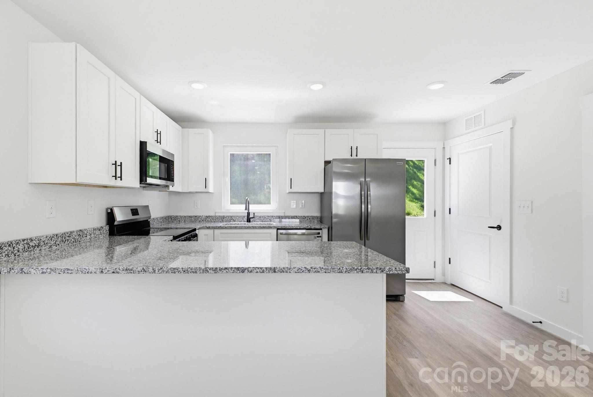 701 2nd St Place Southwest Conover, NC 28613 - Photo 10 of 16 a kitchen with stainless steel appliances granite countertop a sink refrigerator and cabinets