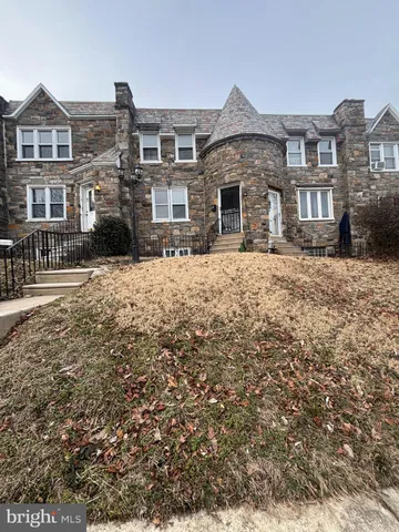 a front view of a residential apartment building with a yard