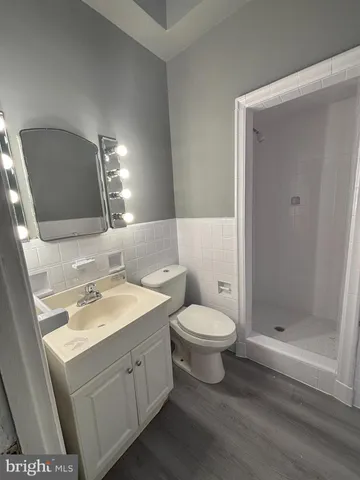 a bathroom with a toilet sink and shower
