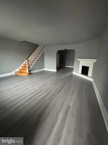a view of a room with wooden floor