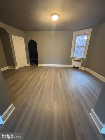 a view of a livingroom with wooden floor and window