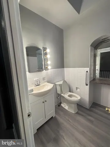 a white toilet sitting next to a bathroom sink