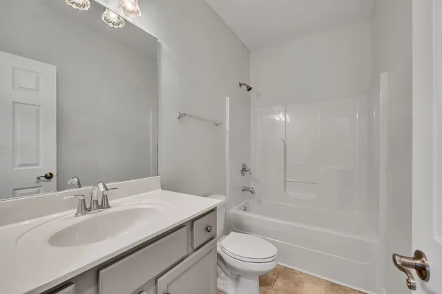 a bathroom with a sink toilet vanity and bathtub