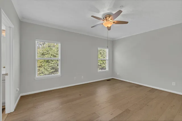 wooden floor in an empty room with a window
