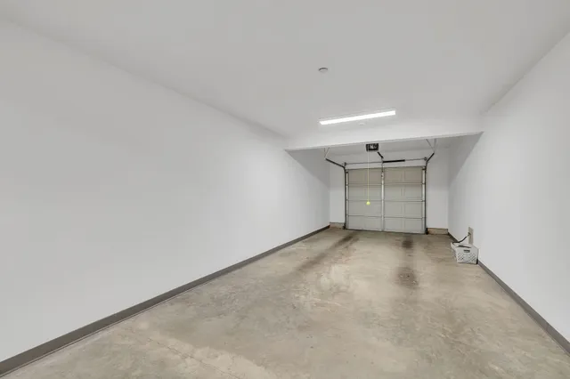 a view of a house with a yard and a garage